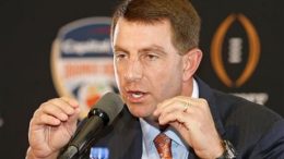 Dabo "Dabo" Swinney demonstrates the movement he needs for completion as Clemson Head Football Coach